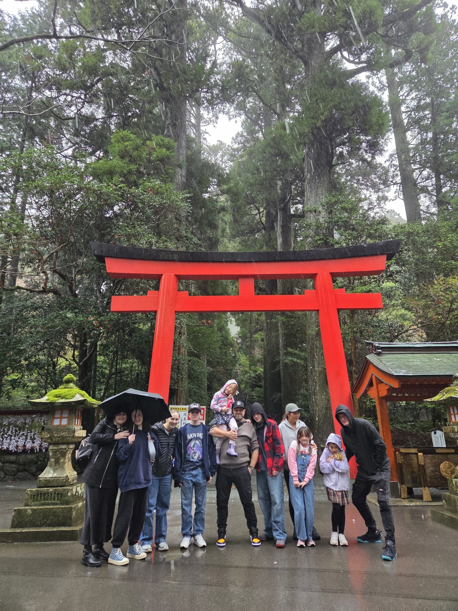 Large escorted coach tour group visiting a landmark in Japan